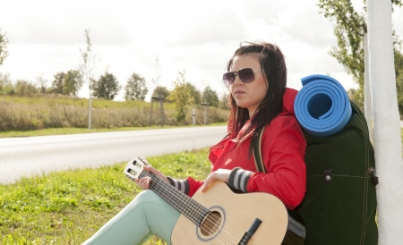 Hitchhiker sitting on the roadside