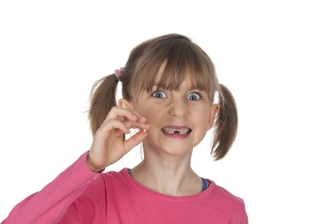  little girl with tooth gap showing milk tooth