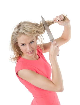 beautiful  woman cutting her hair with  knifeの写真素材