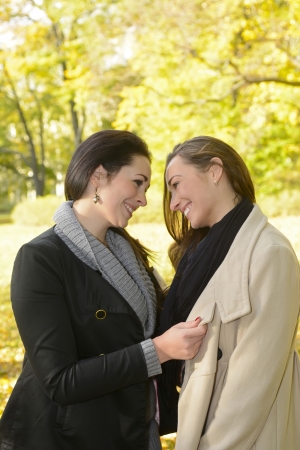  happy girlfriends in autumn parkの写真素材