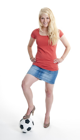 young blond woman with soccer ballの写真素材