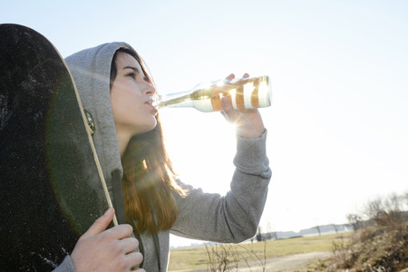 teenager with skateboard and beerの写真素材