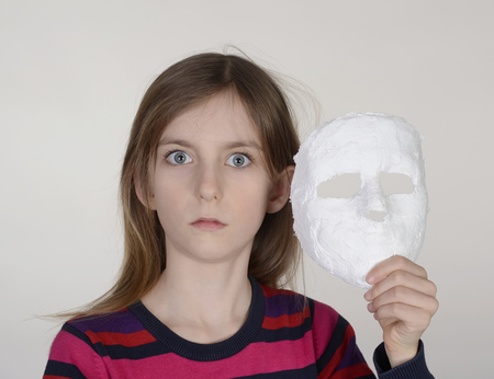 afraid little girl with plaster maskの写真素材