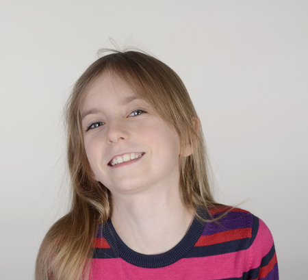 happy little girl against grey background
