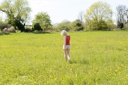 happy young woman with dandelionsの写真素材