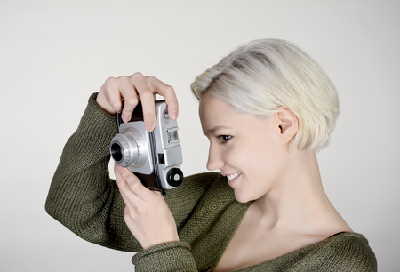 beautiful young woman with old cameraの写真素材