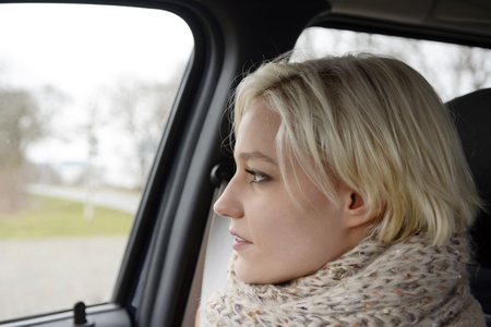 thoughtful young woman waiting in the carの写真素材