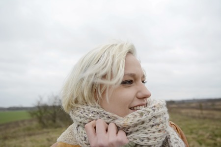 happyl young  blond woman with scarfの写真素材