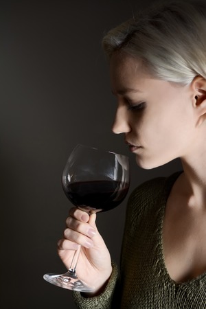 young woman drinking red wine