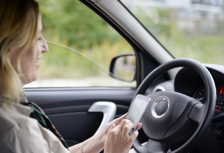 businesswoman writing message in the carの写真素材