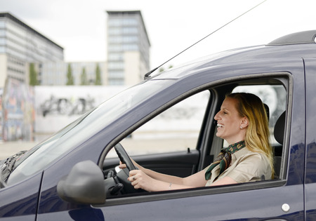 happy businesswoman sitting in the carの写真素材