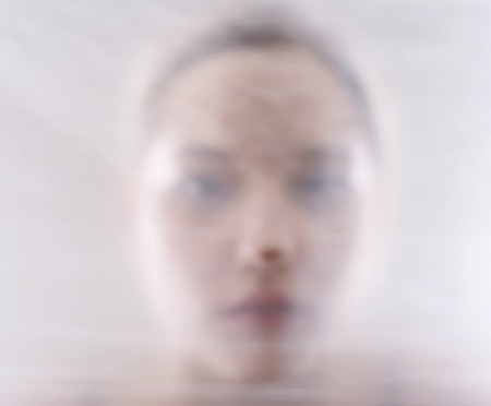 young blond woman behind foilの写真素材