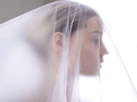  young blond woman behind foilの写真素材