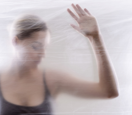 young blond woman behind foilの写真素材