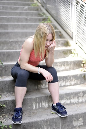 exhausted young blond womanの写真素材