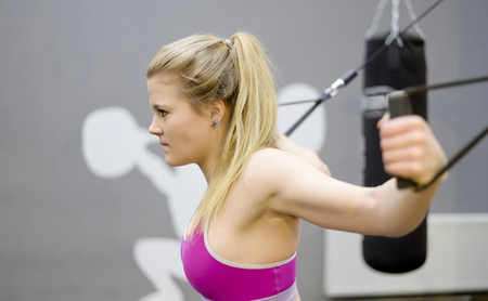 sportive young blond woman in fitness centerの写真素材