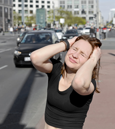 young woman covers her earsの写真素材
