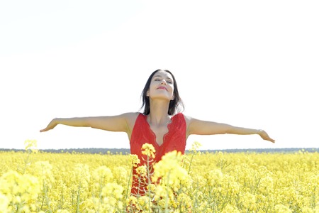 Young woman cheering in the rape field