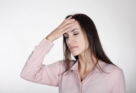 exhausted young businesswoman has headacheの写真素材