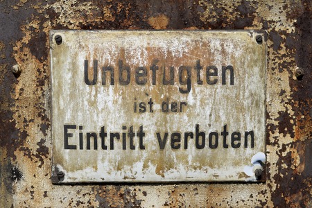 Old rusty warning sign entry forbiddenの写真素材