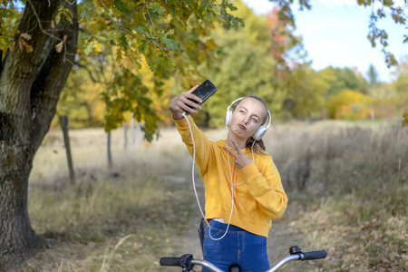 teenager with bicycle and smartphoneの写真素材