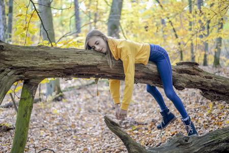 lazy teenager lying on treeの写真素材