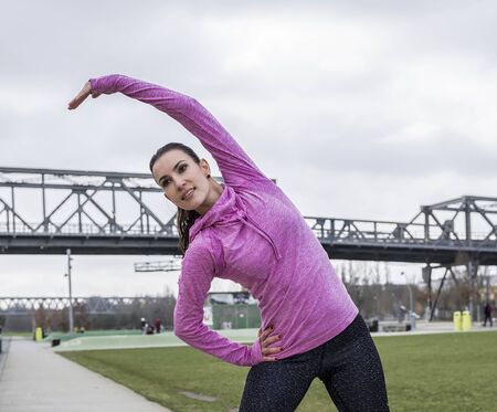young woman doing stretching before joggingの写真素材