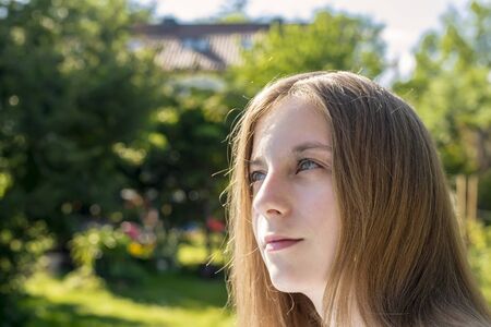 young blond girl in the gardenの写真素材