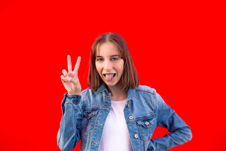 happy young girl showing victory sign