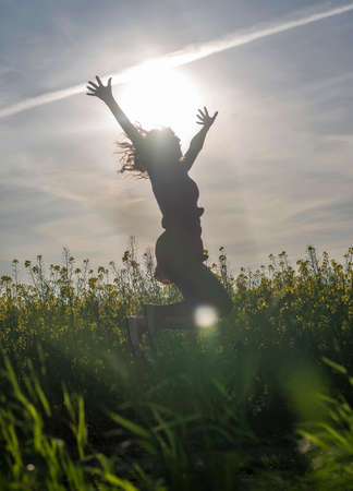 smiling young woman sitting on treeの写真素材