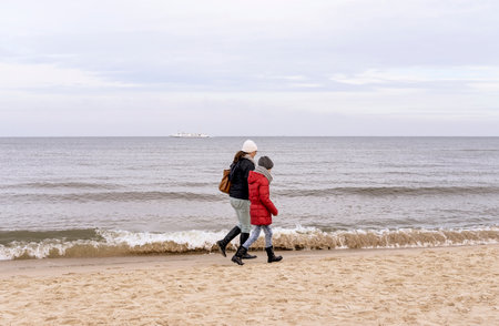 mother and daughter walking on the beachの写真素材