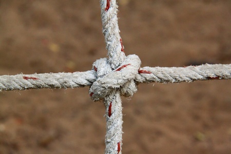 Rope with knots on the background of the sandの写真素材
