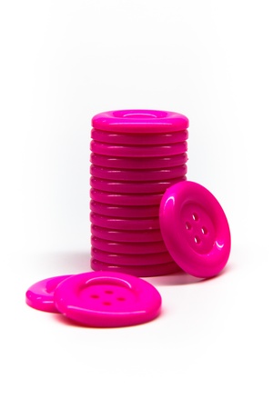 pile of pink buttons on white backgroundの写真素材