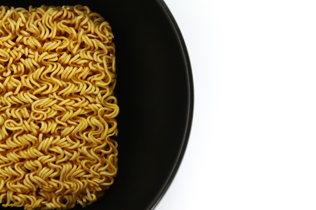 A block of Instant noodles in bowl on white backgroundの写真素材