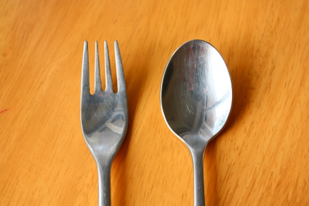 Spoon and Fork on a wood tableの写真素材