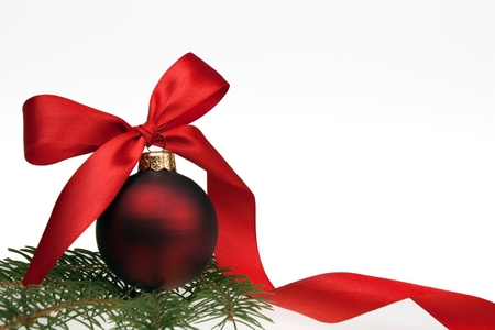 Christmas bauble with red ribbon isolated on white backgroundの写真素材