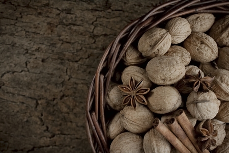 walnuts cinnamon and anise in a basketの写真素材
