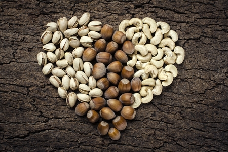 Heart - shaped nuts: hazelnuts, pistachios and cashewsの写真素材