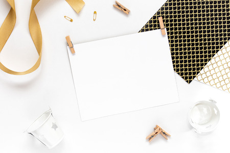 Top view on Beautiful greeting card idea with area for your text with golden ribbon, wooden clothespins copyspace, topview, mockup, flatlay.の写真素材