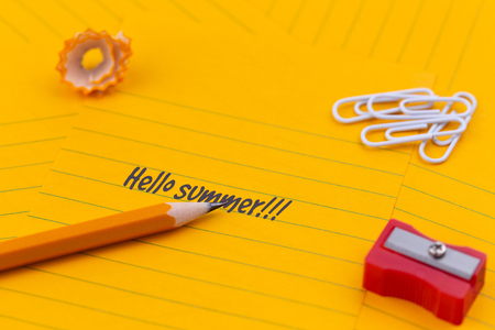 Concept Hello summer or planning a summer trip. Orange sheets of paper, pencil and other stationery objects.の写真素材