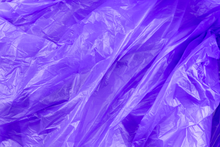 Abstract texture of purple cellophane garbage bag. macro close-up background.