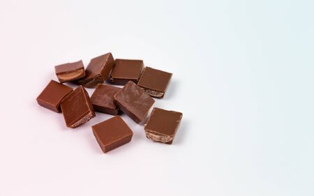 Macro photo of Chocolate bar. Broken pieces over white background.の写真素材