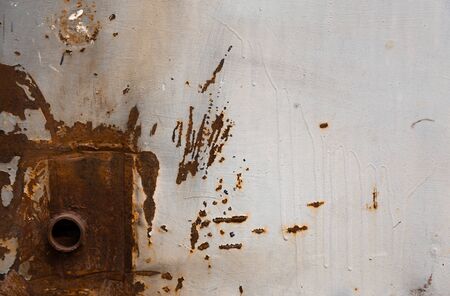 Rusty metal wall, old sheet of iron covered with rust with multi-colored paint.
