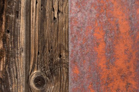 Rusty metal and wooden wall, old sheet of iron covered with rust with paint background texture.の写真素材