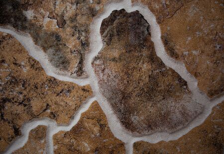 Fragment of a wall from a chipped stone. Wall stone background.