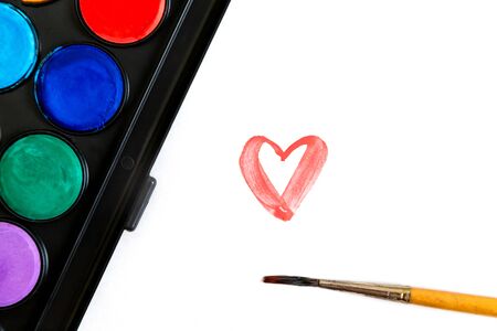 Brush and watercolor paints for drawing, a sheet of paper with heart. The concept of Valentine's Day.の写真素材