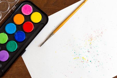 Set of watercolor paints on the white background with copy space for text. Trendy drawing materials for creative artの写真素材