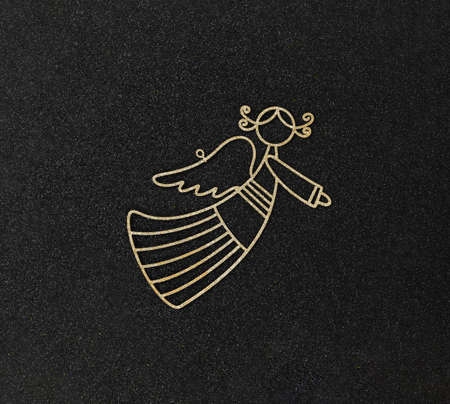 Christmas flatlay layout. Metal toy golden angel on a black glitter shiny background. Christmas card with place for textの写真素材