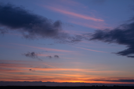 Colorful sunset with clouds in the eveningの写真素材