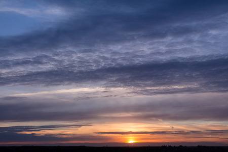 Colorful sunset with clouds in the eveningの写真素材
